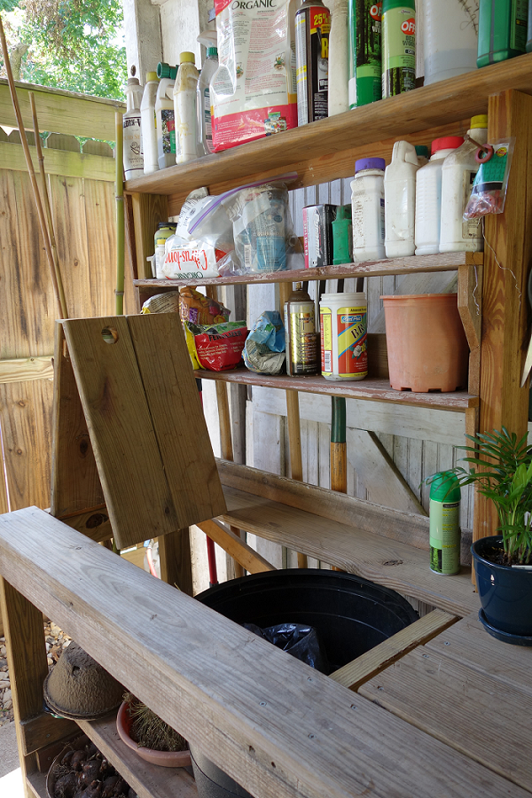 DIY potting bench, hooks, shelves, opens and shuts for potting soil bucket, and it's on wheels!