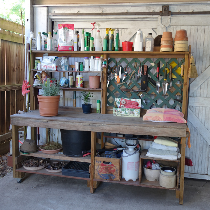 DIY potting bench, hooks, shelves, opens and shuts for potting soil bucket, and it's on wheels!